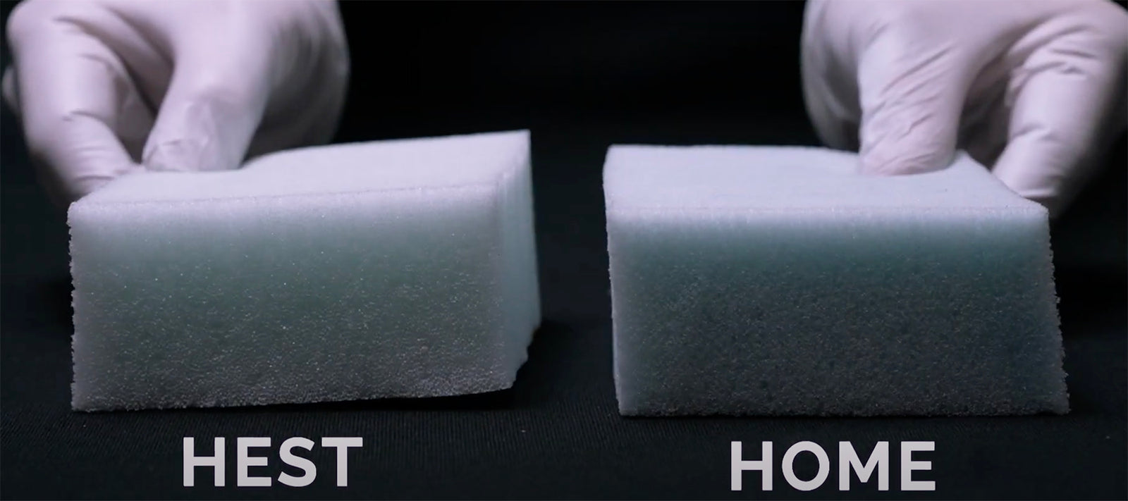 two hands holding memory foam. one foam is from a HEST mattress the other foam is from a home mattress