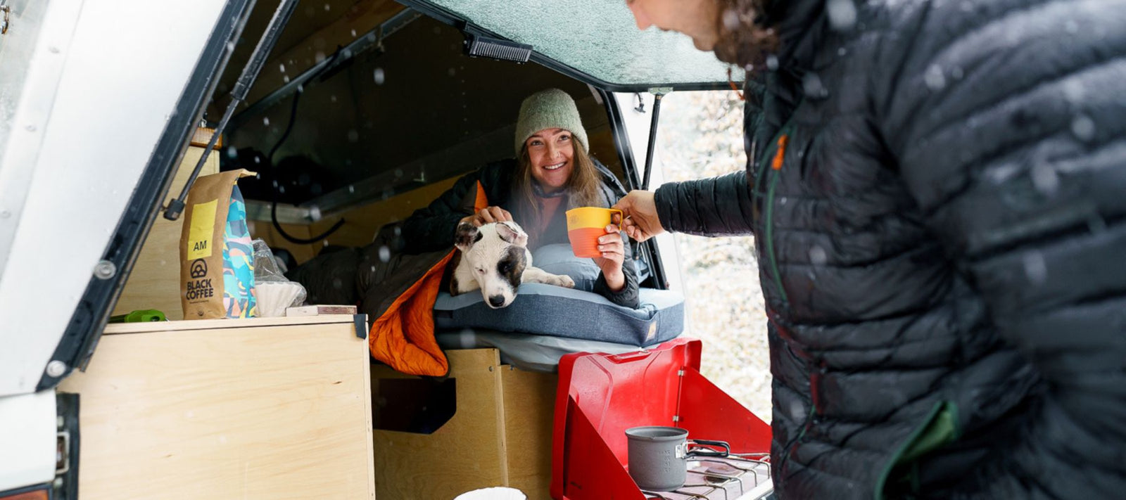 women in back of van with dog 