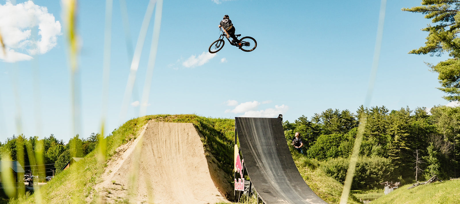 Derek Hines jumping over a redbull jump